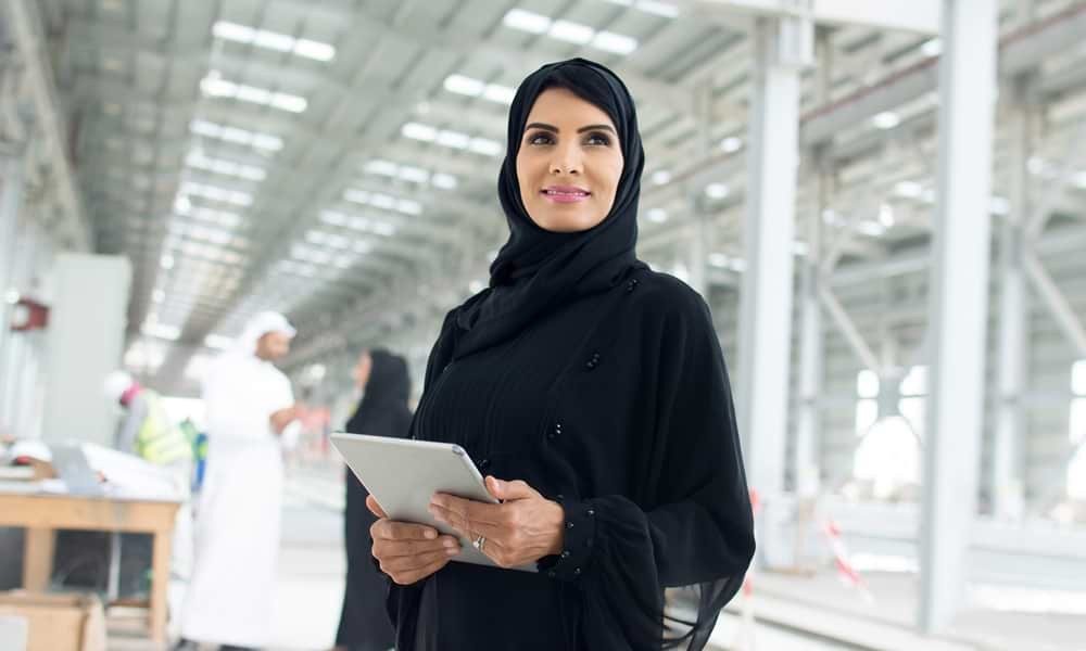 Woman on tablet in factory