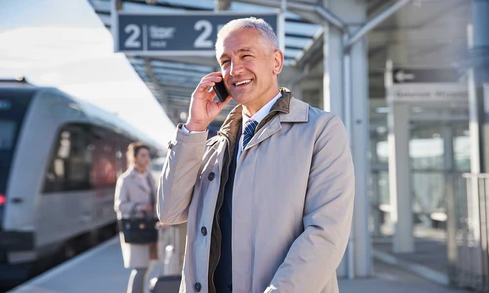 Man talking on phone at train station