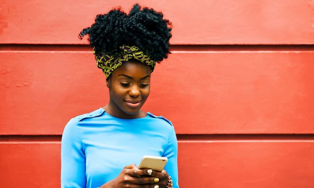 Black woman texting on phone