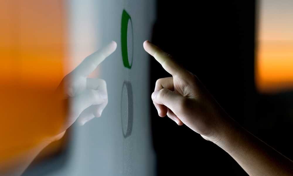 Finger pressing button on large screen