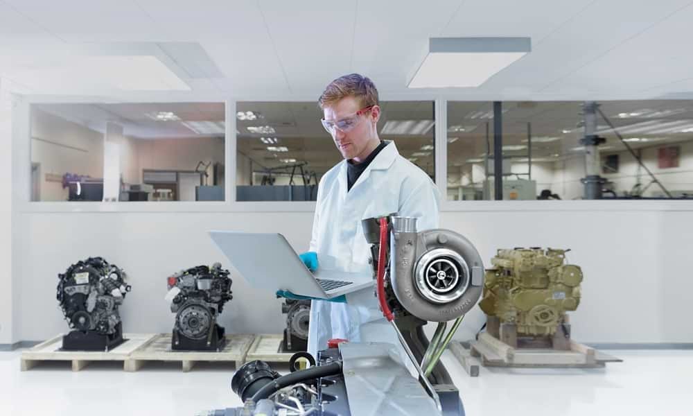Male engineer working on laptop in lab
