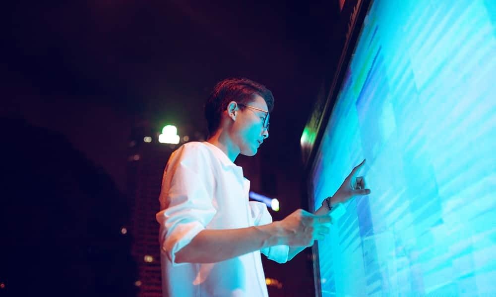 Man working on large screen