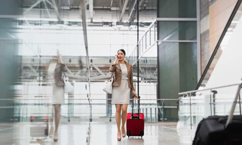 Woman on phone walking through airport