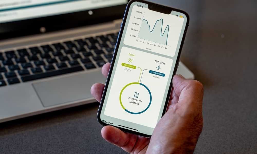 Smartphone showing infographs of of solar energy being used by a business