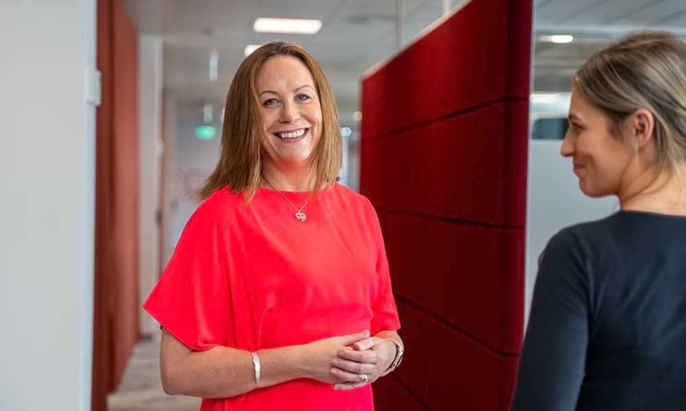 Sheila Kavanagh in conversation with colleagues at Vodafone Ireland's head office in Leopardstown