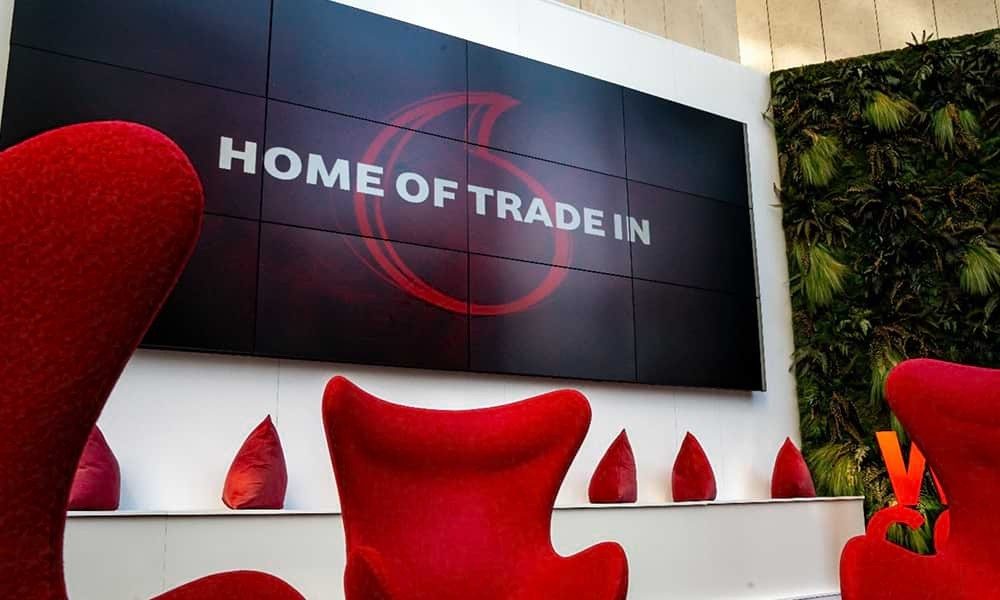 Large TV screen featuring Vodafone logo with text Home of trade in