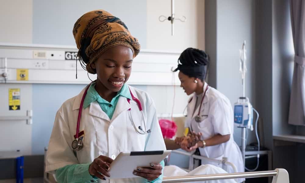 Female doctor looking at tablet