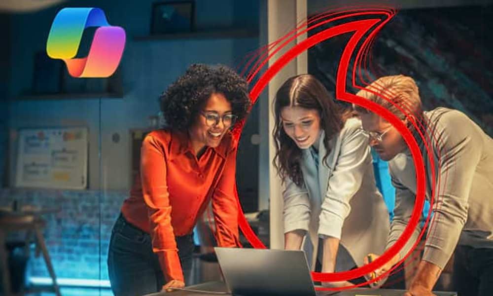 Two women and a man looking at computer