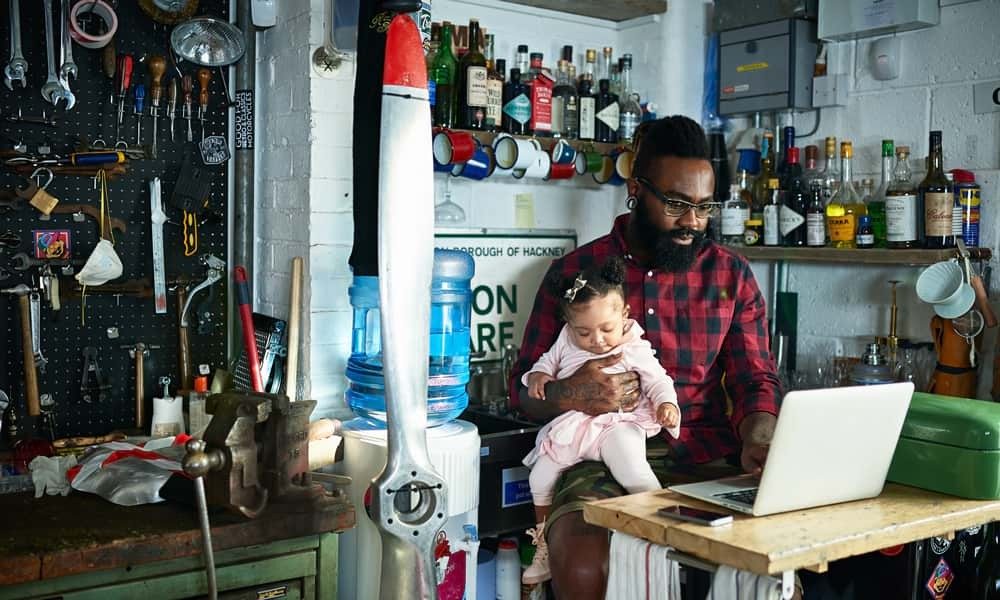 Dad working from home with child