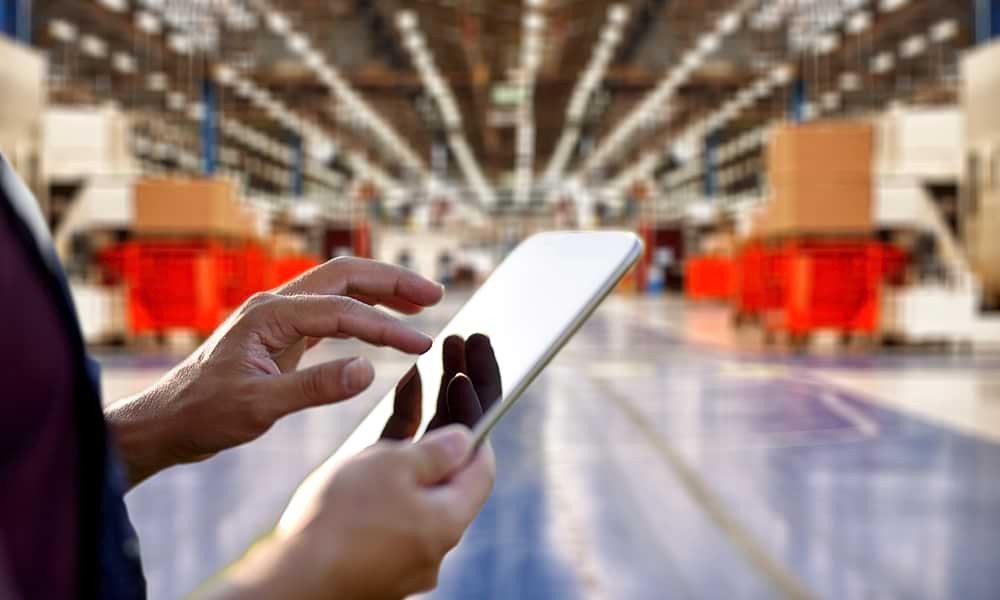 Image of someone working on a tablet in a warehouse