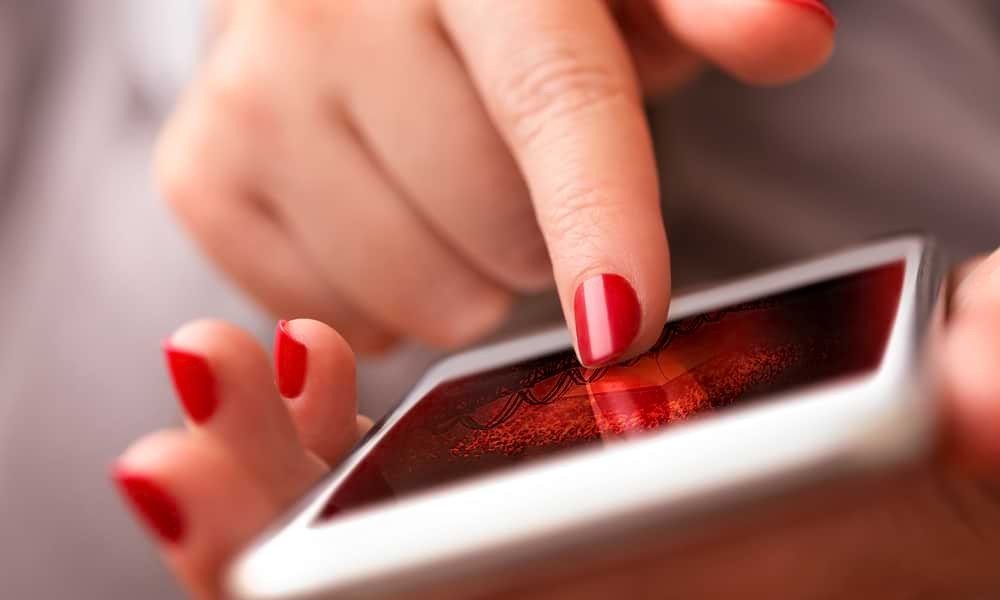 Close up of white woman's hands using smartphone
